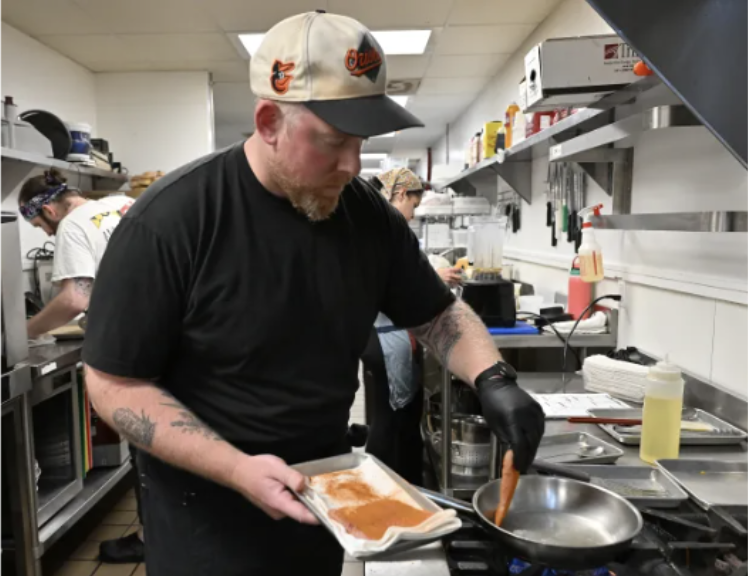 Chef cooks blue catfish